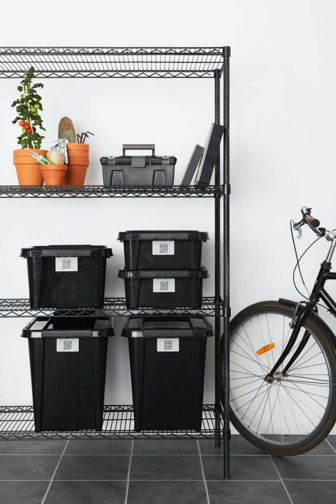 Five stackable Probox Recycle storage boxes made of recycled PP are in three different sizes, equipped with QR codes that help organize your storage. All placed on metal shelves near a bike. Also, Tool Box and Hobby Boxes are visible.