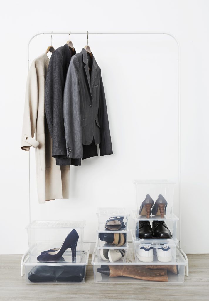 An inspiration for a shoe storage using Basic Shoe boxes. They are available in various sizes to fit every need. Boxes are stacked under hanger with coats.