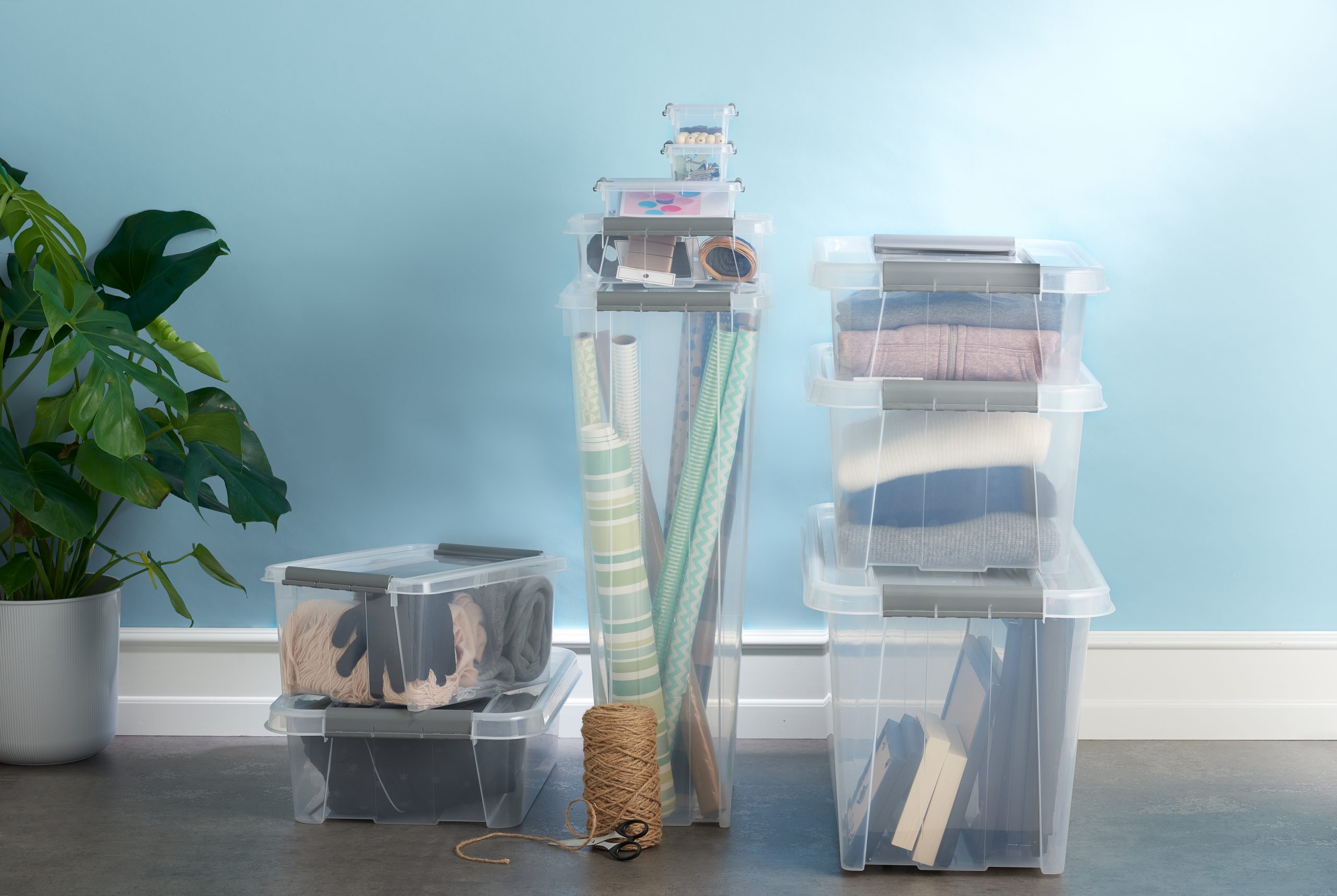 Stackable translucent Probox containers in various sizes with clip closed lids, ideal for clothing storage or household and crafting items storage.