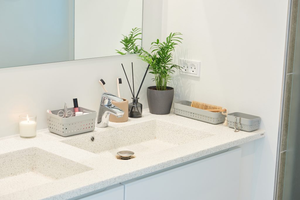 A beautiful and elegant Seoul Organizer system in grey color is used as bathroom storage placed around a sink.